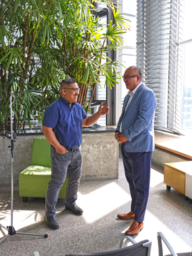 Jon Reyes speaking with a Manitoba Hydro employee.