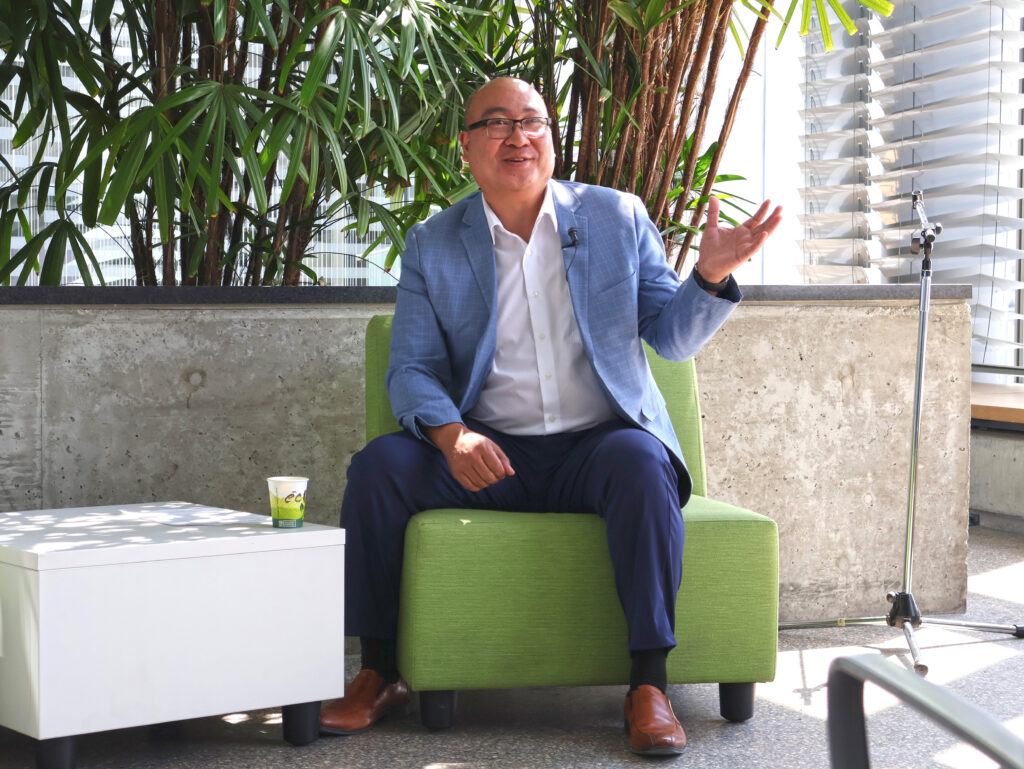 Jon Reyes sitting while addressing the crowd