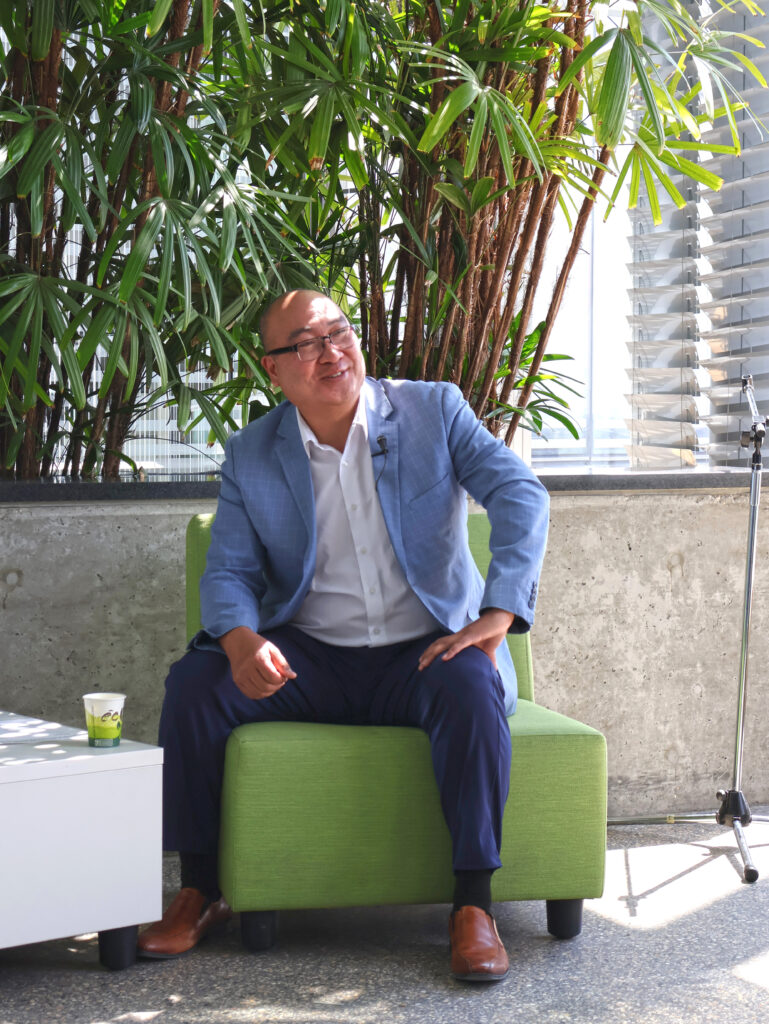 Jon Reyes sitting while addressing the crowd