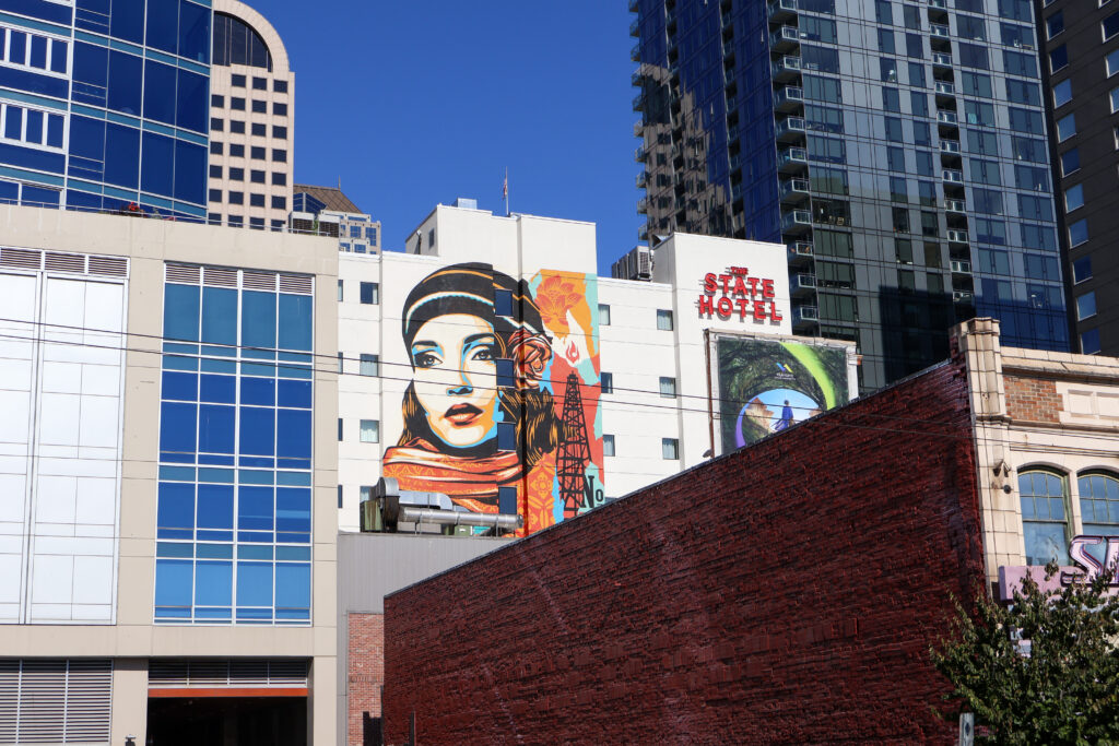 Street art of a fashionable woman on a building in downtown Seattle.