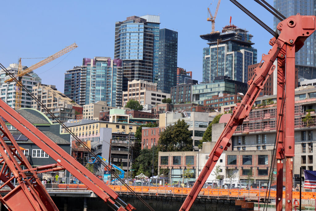 A shot of downtown Seattle framed by two construction cranes.