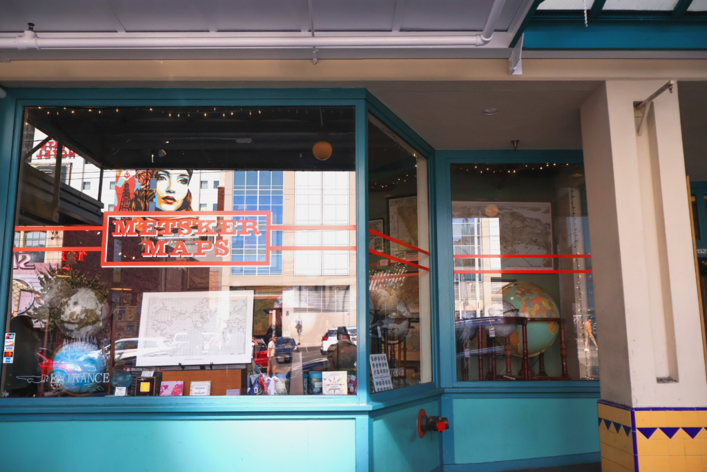 A shop window featuring the reflection of the fashionable street art woman in downtown Seattle.