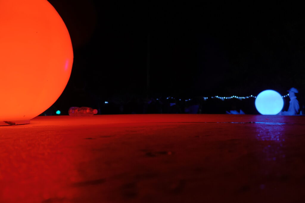 Artistic shot of two glowing orbs in the dark.