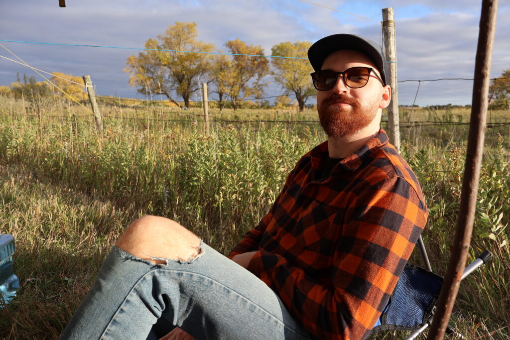 A friend sitting in a field.